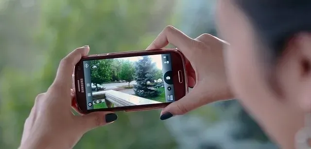 Person using their cellphone camera to take a photo or video.