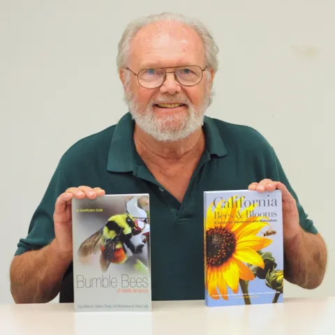 Robbin Thorp with two books he co-authored in 2014. (Photo by Kathy Keatley Garvey)
