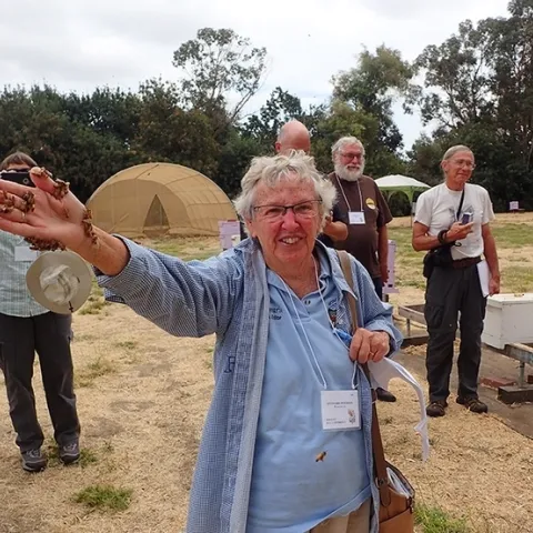 Encouraged by the workshop instructor to hold newly emerged bees, Ettamarie Peterson shows a handful of bees at the Harry H. Laidlaw Jr. Honey Bee Research Facility at UC Davis. (Photo by Kathy Keatley Garvey)