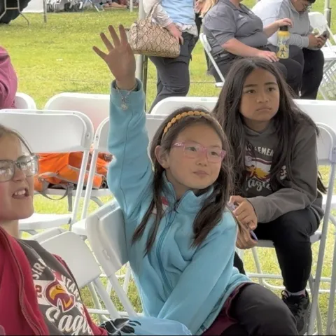 Students enthusiastically engage with a water filtration demonstration during the Children's Water Education Festival