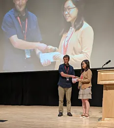 Doctoral student Ching-Jung Lin receiving her second-place award for her presentation on