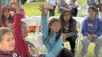 Students enthusiastically engage with a water filtration demonstration during the Children's Water Education Festival