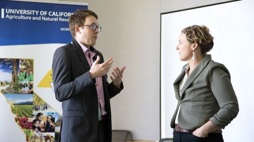 Lenya Quinn-Davidson at right talks with a legislative aide